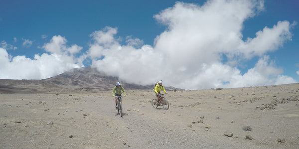 REBECCA RUSH AND PATRICK SWEENEY REACH THE TOP OF THE KILIMANJARO BY BIKE